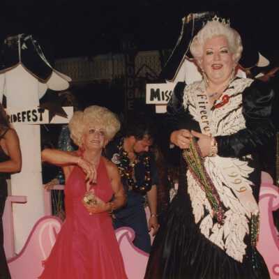 Unknown people dressed up on a float in the parade.