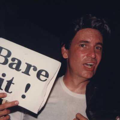Unknown man holding a sign that reads Bare it.