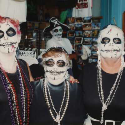 Three unknown woman dressed up.