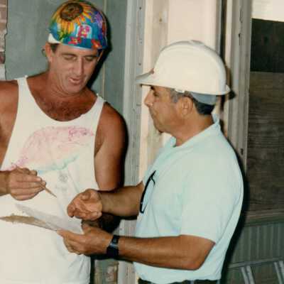 Two unknown men going over plans.