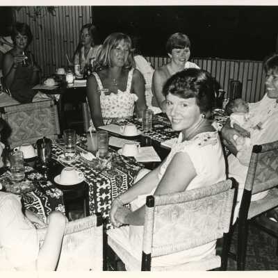 Unknown woman sitting at a table at a party