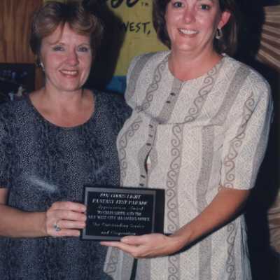 Two unknown woman accepting an award.