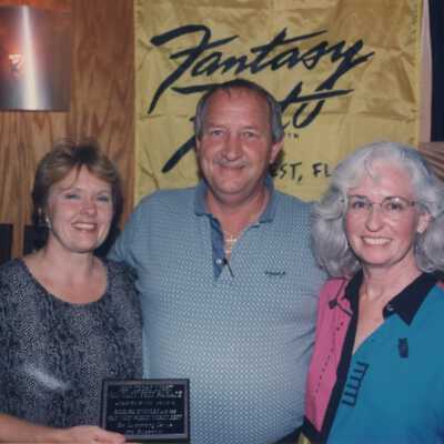 Unknown people accepting an award at the award ceremony.