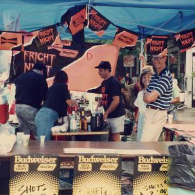 Unknown people at a street fair booth.