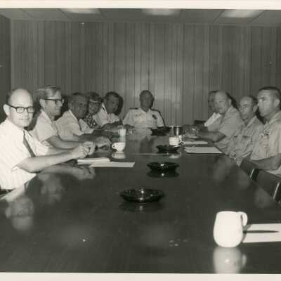 A group of unknown men sitting at a table
