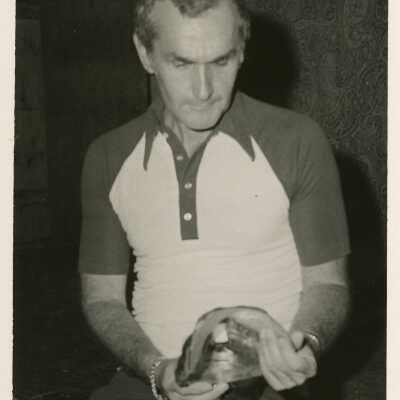 An unknown man holding an unknown object