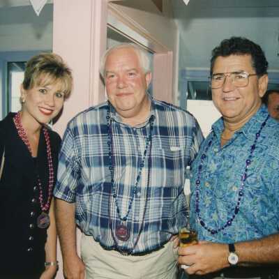 Three unknown people at a ceremony.