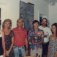 A group of unknown people accepting a trophy.