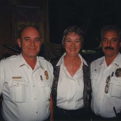 Two unknown cops with an unknown woman.