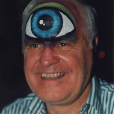 Unknown man with a painted eyeball on his forehead at the Coronation Ball.