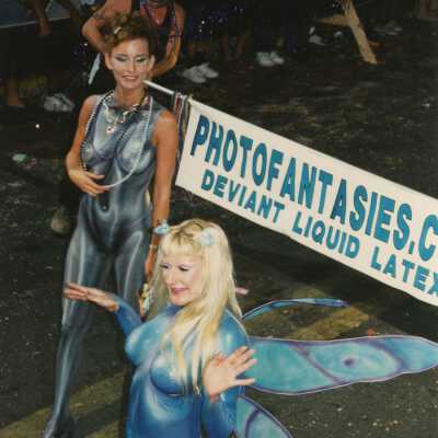 Two unknown woman dressed up walking in the parade.