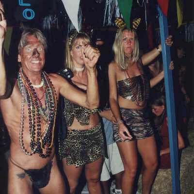 Three unknown people on a float in the parade.