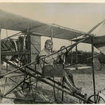 An unknown man sitting in some sort of plane