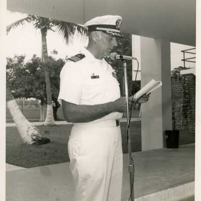 U.S. Navy John Cryer reading at the microphone