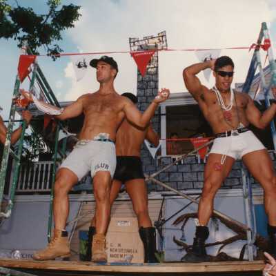 4 unknown men dancing on a stage.