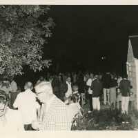 A group of people standing around outside