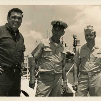 U.S. Navy men standing by a ship