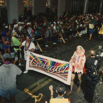 Unknown people holding a banner in the parade that reads Celebrate.