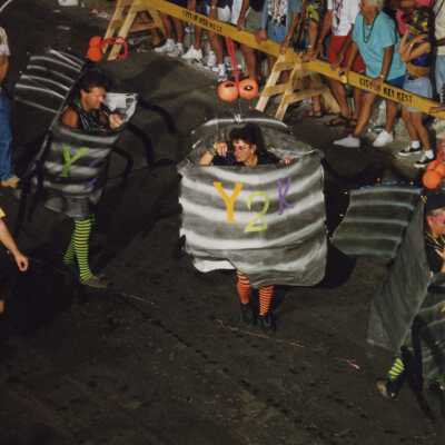 Unknown people dressed up walking in the street for the parade.