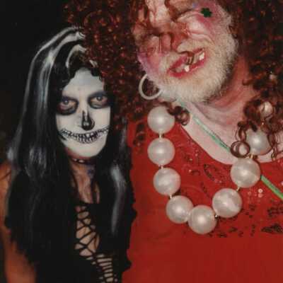 Two unknown people dressed up.