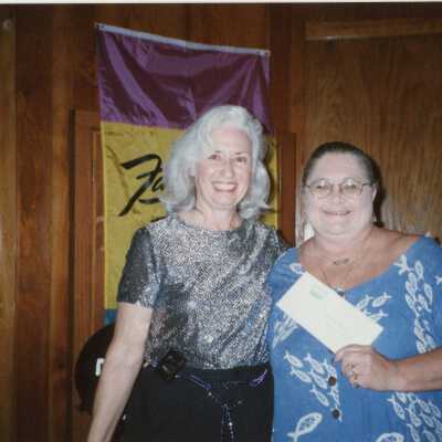 Two unknown woman at an award ceremony.