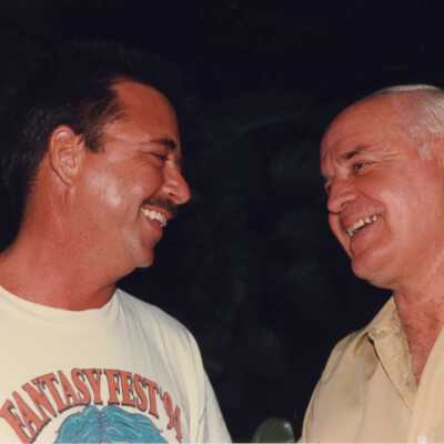 Two unknown men talking at the awards ceremony.