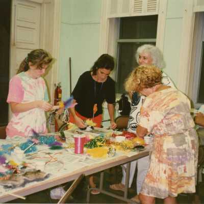A group of unknown people making face masks.