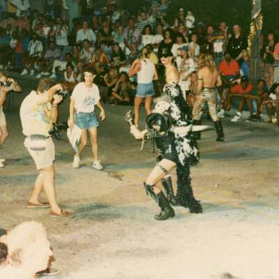 Unknown people with cameras taking pictures of an unknown person dressed up.