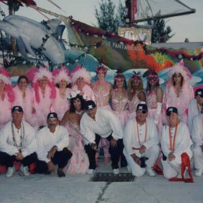 Unknown people dressed up in front of a float.