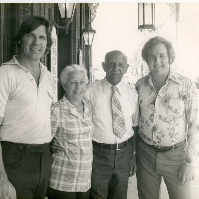4 Unknown people standing in front of a building