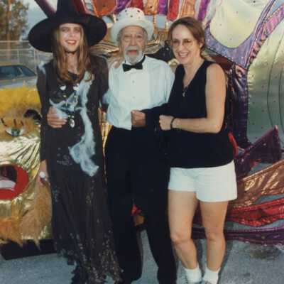 Capt. Tony and two unknown woman standing with a float.