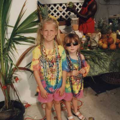 Two unknown children wearing beads.