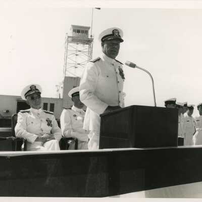 Men in uniform at the podium at a ceremony