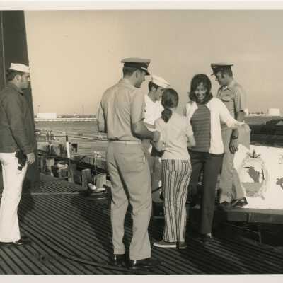 A group of unknown people standing on a ship
