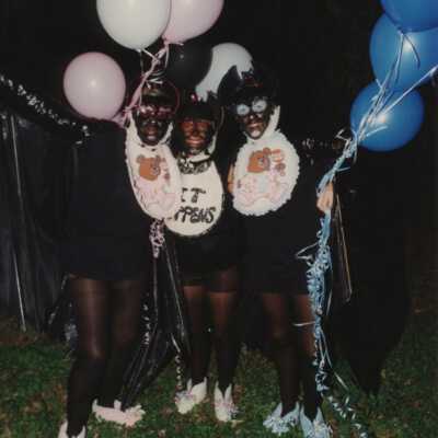 Three unknown people dressed up.