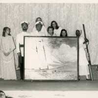 A group of unknown people with a piece of artwork