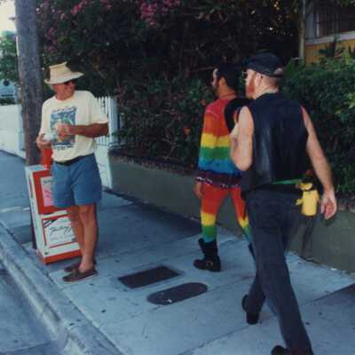 Unknown people walking down a sidewalk.