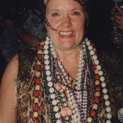 Unknown woman with a lot of beads around her neck.
