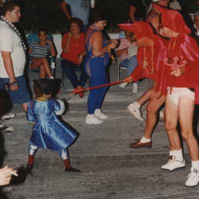 A group of unknown people, a few are dressed up.