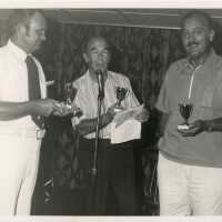 3 Unknown men each holding a trophy