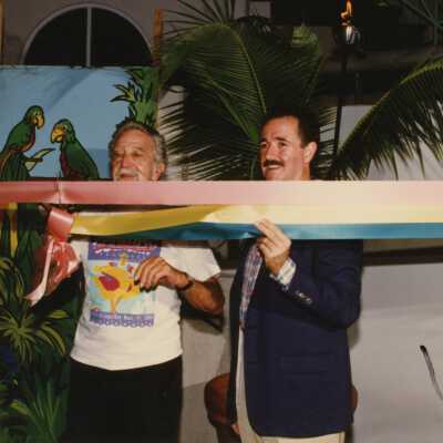 Captain Tony and an unknown man doing a ribbon cutting.