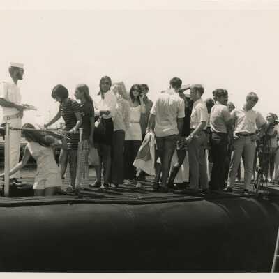 A group of unknown people standing on a ship