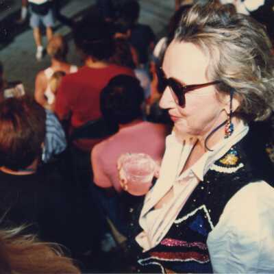 Unknown woman with a drink in her hand.