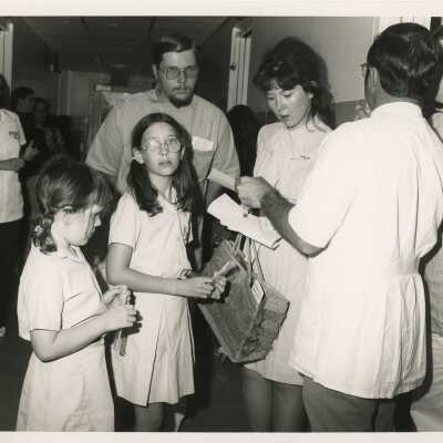 A group of unknown people dancing and standing around