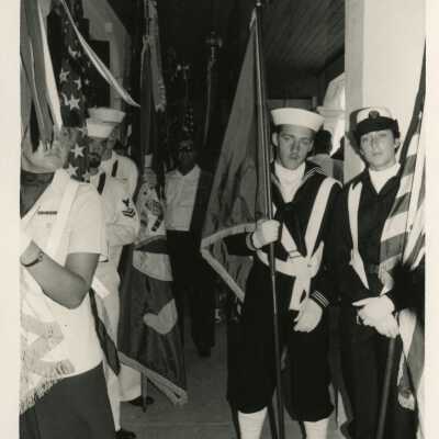 A group in uniform holding flags