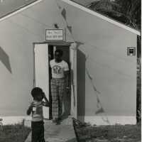 A man and child walking out of the Blue Bee Bar