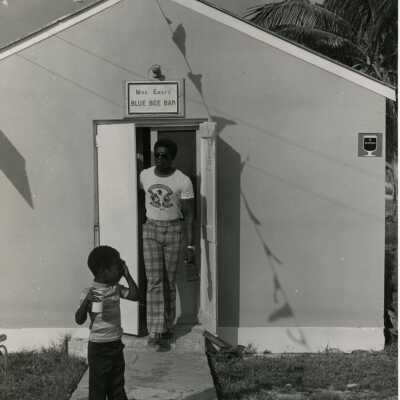 A man and child walking out of the Blue Bee Bar