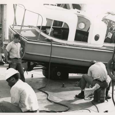 U.S. Navy men working on a boat