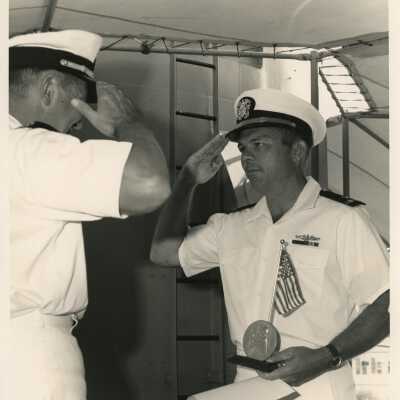 U.S. Navy men saluting each other