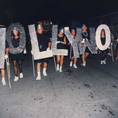 Unknown people holding letters that make up the word Hollywood.